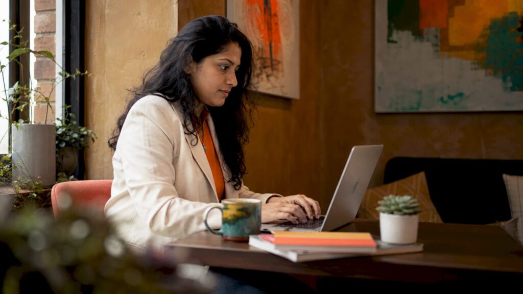 Consultant composing LinkedIn message at desk