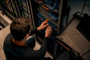 Hands connecting cables to server unit