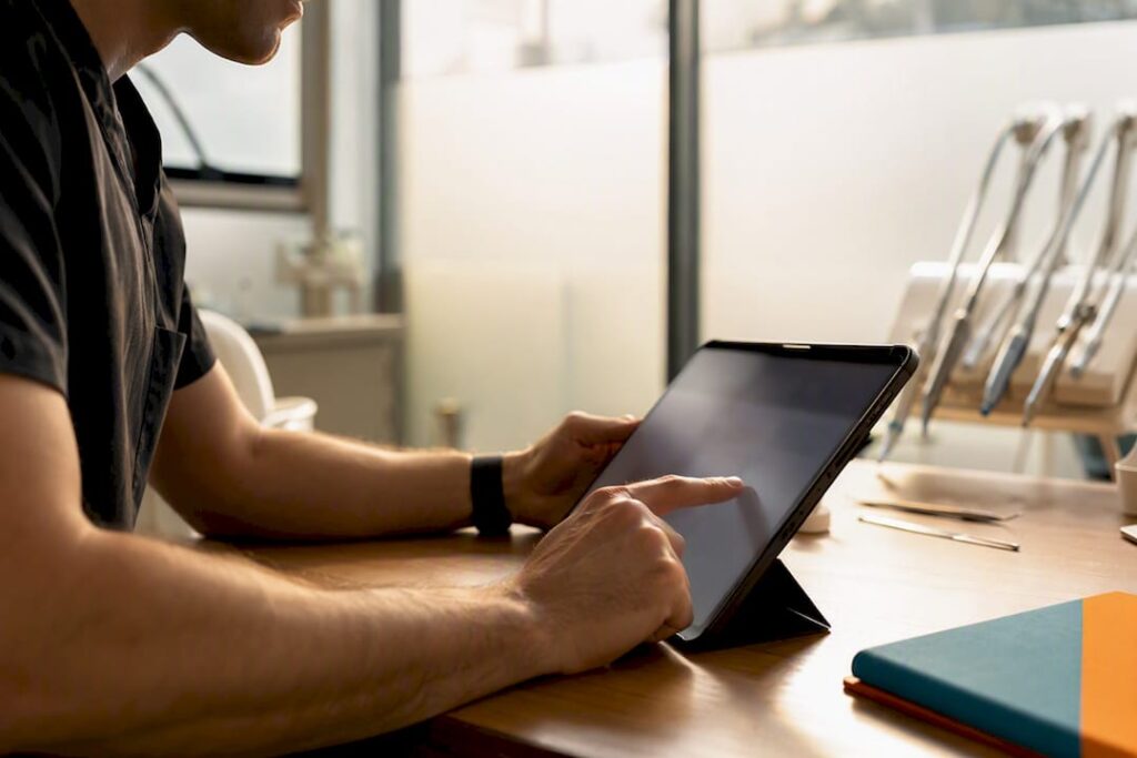 Hands adjusting dental marketing dashboard